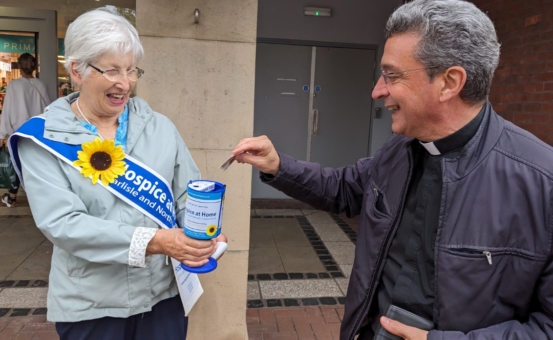Anne getting a donation from a vicar at Carlisle Street Collection