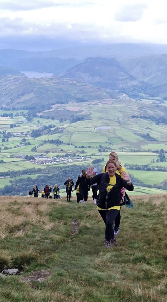 Walkers waving on the way to the top of Blencathra