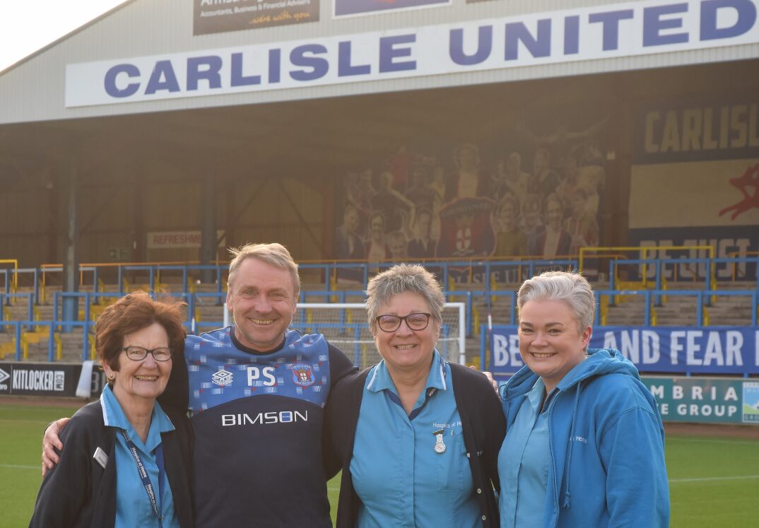 Carlisle United Manager with Hospice at Home Nurses at Carlisle United pitchside.